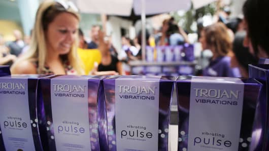 People receive a free vibrator sex toy which was being distributed by the Trojan condom company from their 'Pleasure Carts' on August 9, 2012 in New York City.