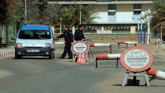Algerian policemen stop cars at a checkpoint in In Amenas, deep in the Sahara near the Libyan border.
