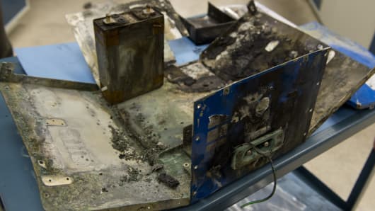 The damaged battery case from a fire aboard a Japan Airlines (JAL) Boeing 787 Dreamliner airplane at Logan International Airport in Boston is displayed inside an investigation lab at National Transportation Safety Board (NTSB) Headquarters in Washington, DC.