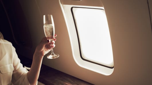 Premium: inside wealth private jet woman champagne