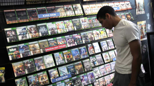 A customer shops for a video game to purchase.