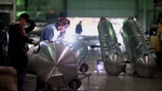 An employee welds mounting brackets to an aluminum pontoon during the fabrication process at the Nautic Global Group production facility in Elkhart, Indiana, U.S.