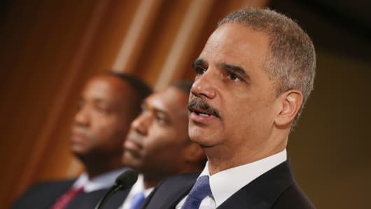 U.S. Attorney General Eric Holder leads a news conference with Acting Associate Attorney General Tony West, Principal Deputy Assistant Attorney General Stuart Delery and attorneys general from eight states and the District of Columbia at the Department of