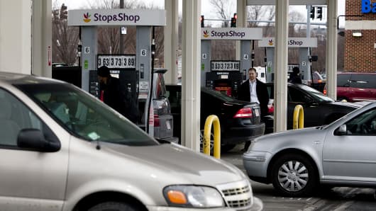 Customers line up to fill up fuel tanks at the Stop and Shop gas station in Boston, Massachusetts, U.S., on Friday, Feb. 8, 2013.
