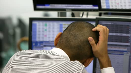 A trader monitors the foreign exchange and stocks index in Tokyo.