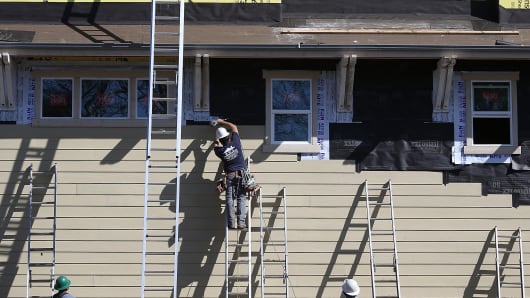 Construction workers are seen on the job at a new housing development in San Mateo, California.