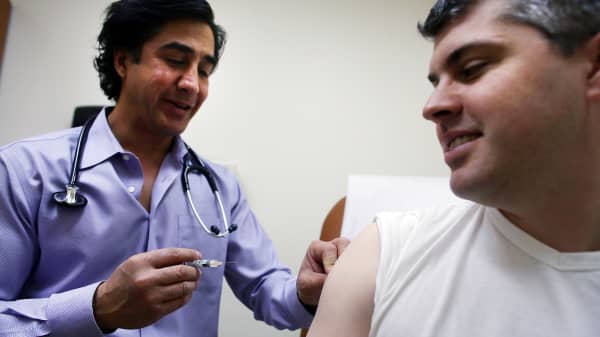 Aaron Lemma receives a flu shot by Dr. Sassan Naderi at the Premier Care walk-in health clinic which administers flu shots on January 10, 2013 in New York City.