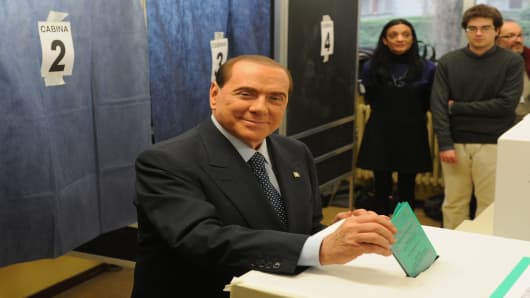 Former Italian Prime Minister Silvio Berlusconi casts his vote in a polling station on February 24, 2013 in Milan, Italy.