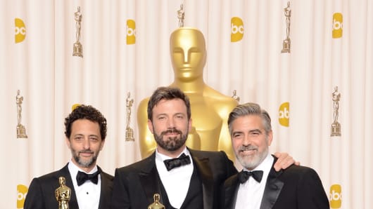 Grant Heslov, Ben Affleck, and George Clooney, winners of the Best Picture award for 'Argo,' pose in the press room during the Oscars.