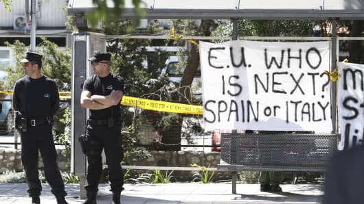 Cypriot security guards stand outside the parliament building in Nicosia.
