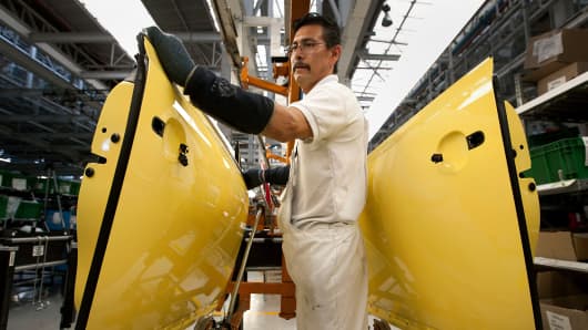 An employee works on the production line at a Volkswagen assembly plant in Puebla, Mexico.