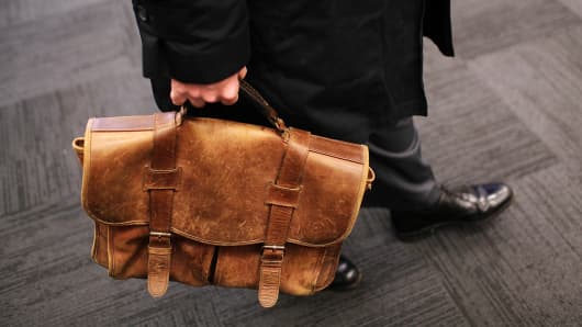 A job seeker carries a worn briefcase at the Green Jobs and Entrepeneurship Fair in Berkeley, California.