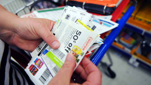 A woman sorts through coupons while shopping in California, Md.