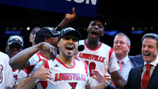 The Louisville Cardinals celebrate after winning against Syracuse during the final of the Big East Men's Basketball Tournament in March 2013.