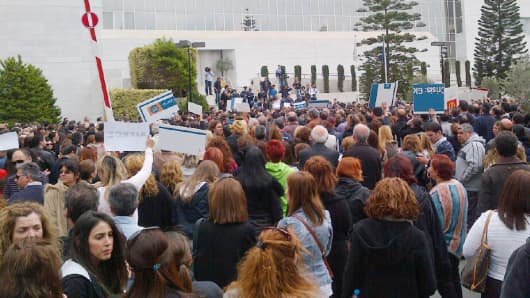 Bank of Cyprus employees move demonstration from their headquarters to the Central Bank of Cyprus (the buildings are next door to each other).  They chanted "resign, resign, resign" - calling for the Governor of the Central Bank to step down.