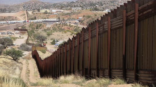 A fence separates the cities of Nogales, Arizona (L) and Nogales, Sonora Mexico.