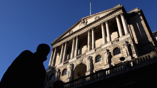 A city worker walks past the Bank of England in central London.