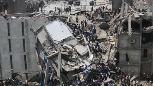 People rescue garment workers trapped under rubble at the Rana Plaza building after it collapsed, Bangladesh, India.