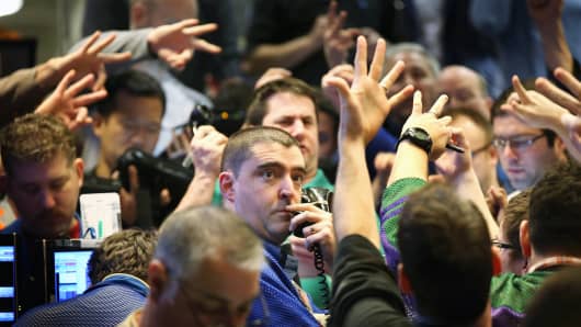Traders signal offers in the Standard & Poor's 500 stock index options pit at the Chicago Board Options Exchange (CBOE).