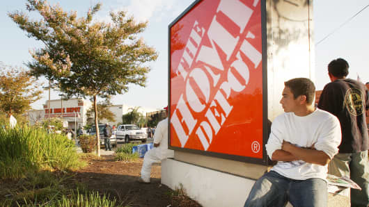 Day laborers wait near a Home Depot home improvement store in hope of finding work for the day in Los Angeles, California.