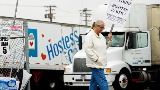 A production worker for Hostess Brands pickets in Sacramento, Calif., in November.
