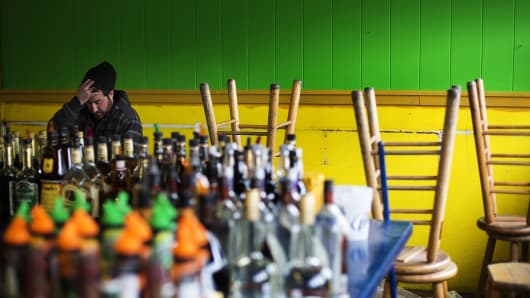A worker at Jack N Bill's in Seaside Heights, NJ, prepares to open the bar for the summer tourist season.