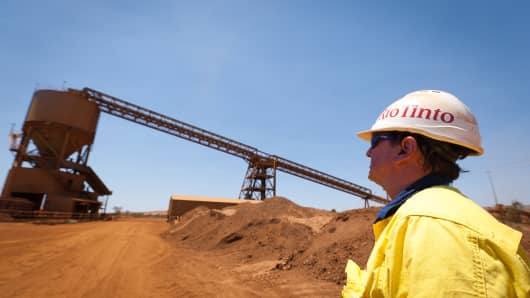 A mine worker looks at a train loader at Rio Tinto Group's West Angelas iron ore mine in Pilbara, Australia.