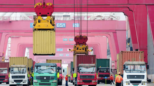Shipping containers are transported in a port in Qingdao, east China's Shandong province.