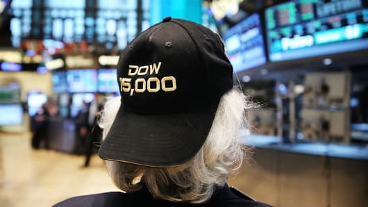 A trader on the floor of the New York Stock Exchange wears a hat embroidered with 15,000 at the end of the trading day on May 7, 2013 in New York City.