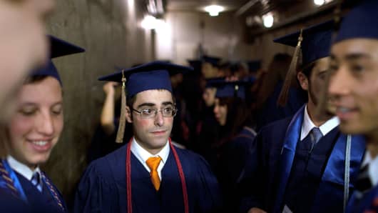 Steve Heiss stands with fellow graduates before participating in commencement ceremonies from the University of Illinois at Urbana-Champaign on May 11, 2013.