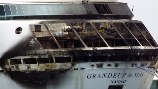 The fire-damaged exterior of Royal Caribbean's Grandeur of the Seas cruise ship is seen while docked in Freeport, Grand Bahama island, Monday, May 27, 2013.