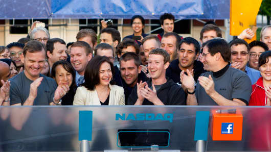 Mark Zuckerberg, CEO of Facebook, center, Sheryl Sandberg, COO, center left, and Robert Greifeld, CEO of Nasdaq OMX Group, center right, on IPO day on May 18, 2012.