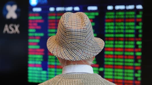 A retiree watches stock prices on the Australian Stock Exchange (ASX) in Sydney, Australia.