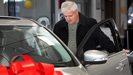 Customer Steve Mihalopoulos views a Ford Motor Co. Focus vehicle displayed for sale at Golf Mill Ford car dealership in Niles, Illinois, U.S.