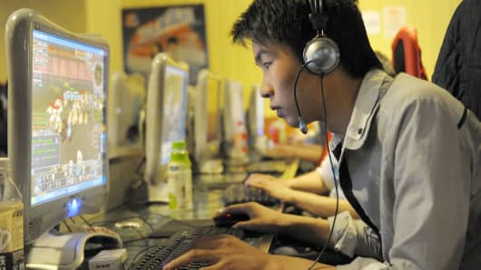 A chinese man plays online games at an internet cafe in Beijing.