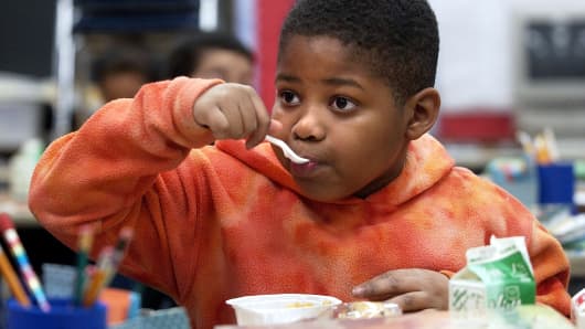 A free school breakfast program in Denver. The teacher believes that about half of the students in the second grade do not get breakfast at home.