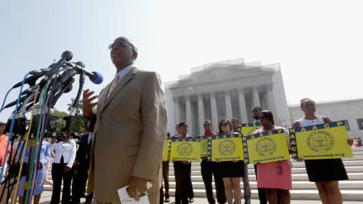 Field Director Charles White of the National Association for the Advancement of Colored People (NAACP) speaks at a podium outside the U.S. Supreme Court building on June 25, 2013 in Washington, DC.