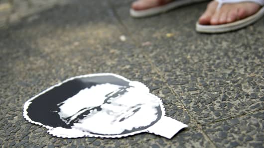 A cardboard mask of Edward Snowden on the ground at a protest against the PRISM surveillance program, which Snowden leaked.