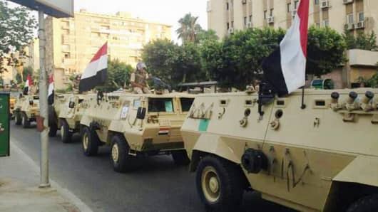Egyptian military armored vehicles begin to enter central Cairo on July 3, 2013.