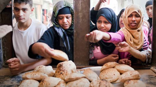 Customers buying bread in Cairo, Egypt.