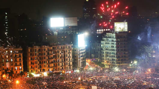 Fireworks emanate from Tahrir Square after a broadcast by the head of the Egyptian military confirming that they will temporarily be taking over from the country's first democratically elected president Mohammed Morsi on July 3, 2013 in Cairo, Egypt.