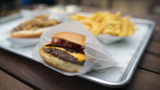 A Shake Shack cheeseburger with a portion of fries outside the company's new burger restaurant in London