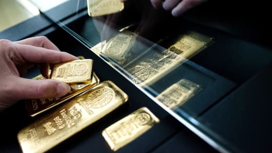 A customer examines a selection of gold bars from Swiss manufacturer Argor Hebaeus SA.