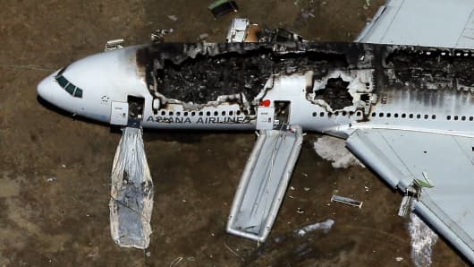 A Boeing 777 airplane lies burned on the runway after it crash landed at San Francisco International Airport July 6, 2013 in San Francisco, California.