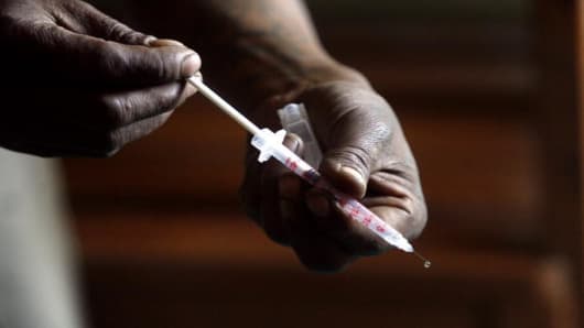 A heroin user prepares his syringe.