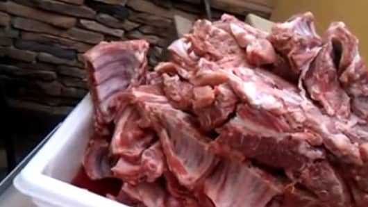 A YouTube video exposes baby back ribs stored in the garbage disposal area at a Golden Corral restaurant.