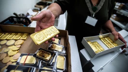 An employee returns a box of One kilogram gold bars to the safe, from Swiss manufacture Argor Hebaeus SA.