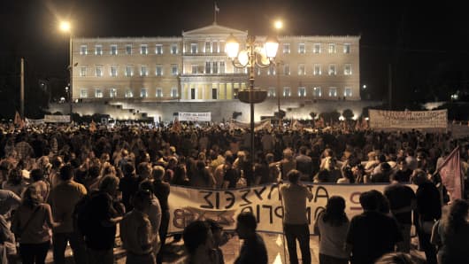 Demonstrators protest against the Greek Government, July 17, 2013 in front of the parliament as lawmakers prepared to vote on a controversial new austerity package.