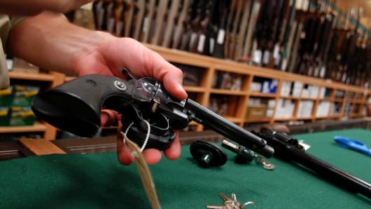An employee places gun locks on guns for sale at Cabela's in Hamburg, Pennsylvania.
