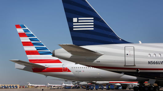 An American Airlines plane (left) and a USAirways jetliner at Dallas-Fort Worth.